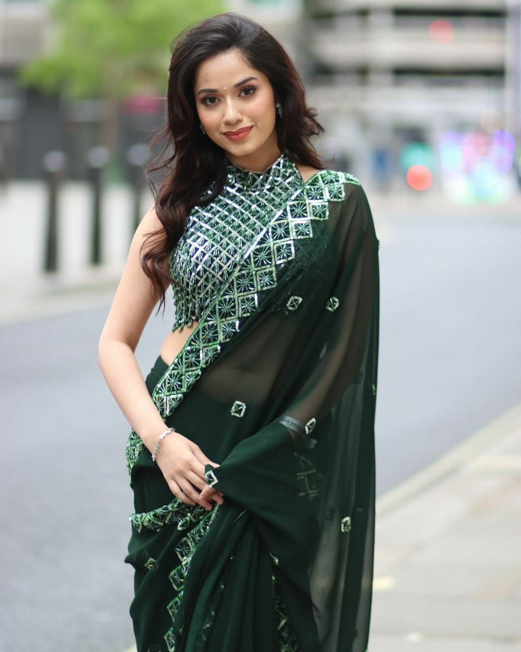 Elegant woman wearing a soft Rangoli silk saree with intricate sequence embroidery and a matching blouse.