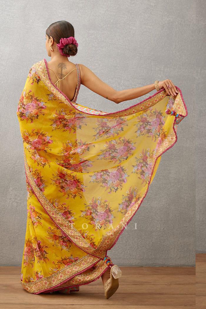 Trendy yellow georgette saree with floral digital print and intricate lace border for women.