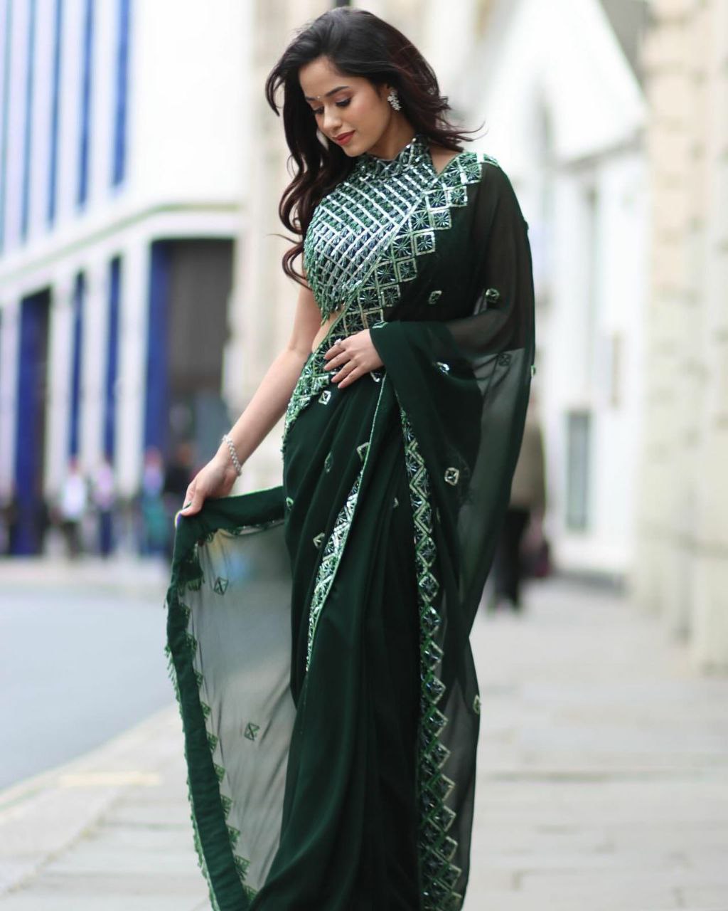 Elegant woman in a soft Rangoli silk saree with beautiful sequence embroidery, perfect for special occasions.