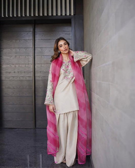 Trendy women salwaar set featuring embroidered top and printed organza dupatta in pink and cream color.