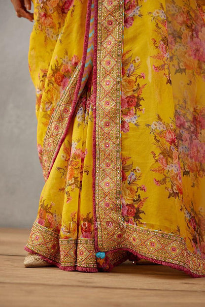 Trendy yellow georgette saree for women with floral print and embroidered lace border.