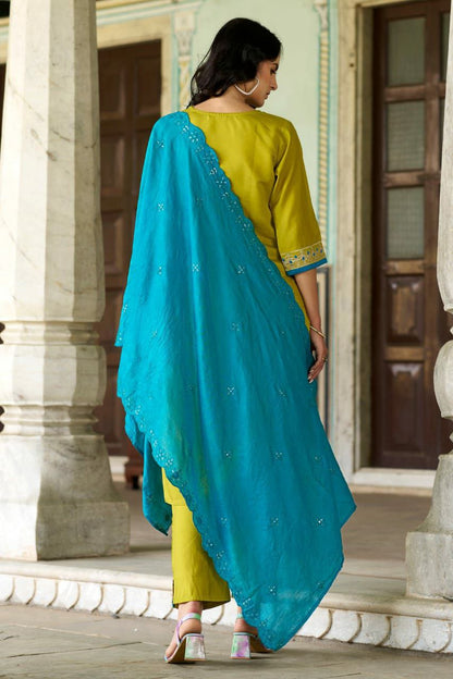 Back view of a woman wearing a kurti set with a turquoise dupatta, showcasing embroidery details.