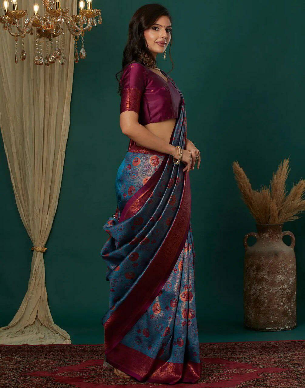 Woman in a traditional saree  chandelier and vase.