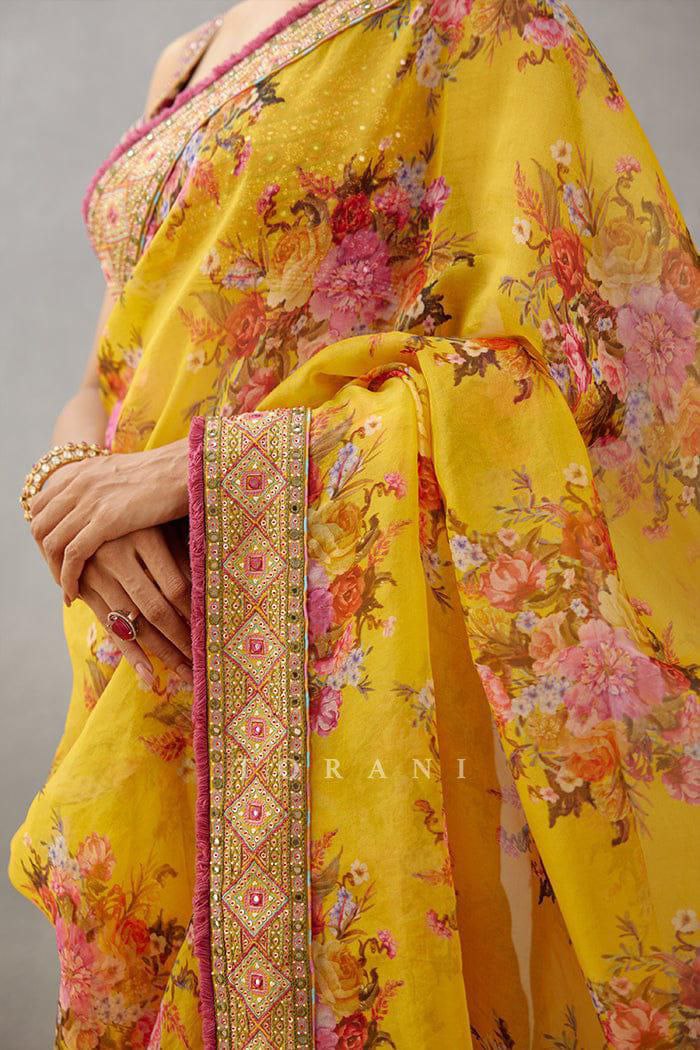 Trendy yellow georgette saree with floral digital print and embroidered lace border, perfect for women.